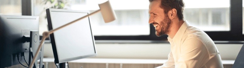 Man working on computer and happy